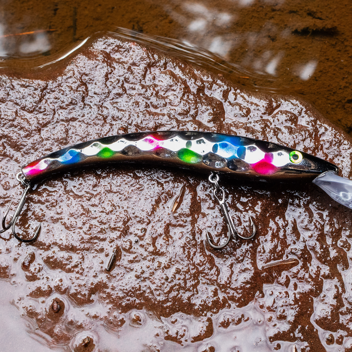 reef runner hammered 800 fishing lure on a wet rocky surface